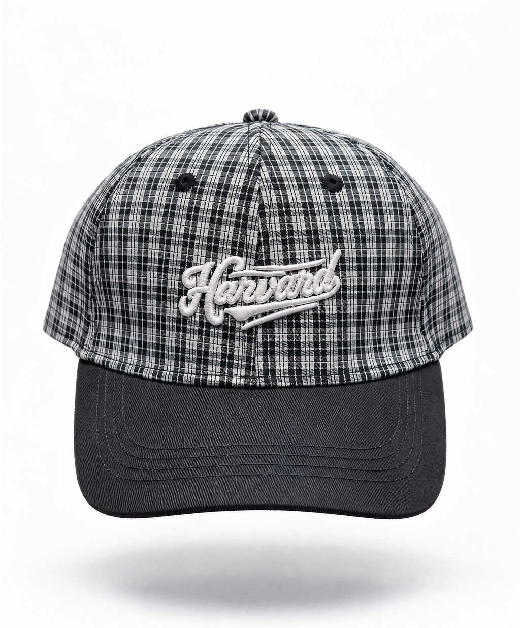 A baseball cap featuring a black and white plaid pattern on the crown with a solid black curved brim. The front of the cap has an embroidered white script logo reading 'Harvard'.