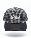 A baseball cap featuring a black and white plaid pattern on the crown with a solid black curved brim. The front of the cap has an embroidered white script logo reading 'Harvard'.