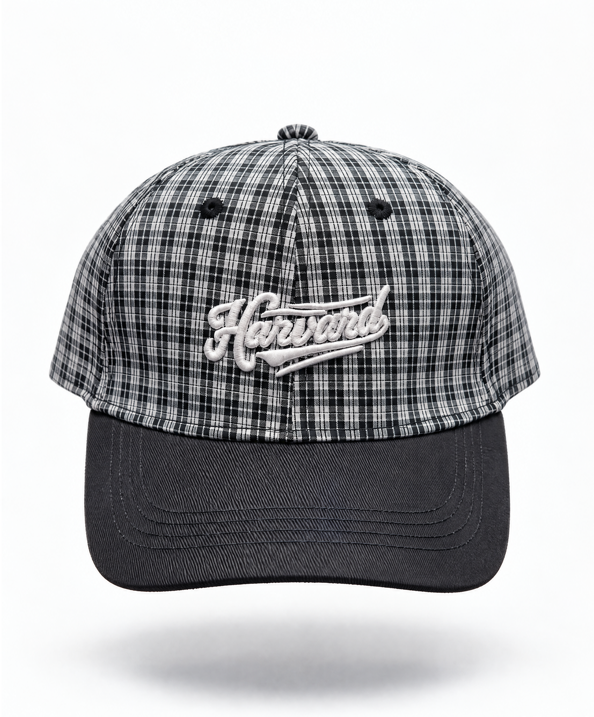 A baseball cap featuring a black and white plaid pattern on the crown with a solid black curved brim. The front of the cap has an embroidered white script logo reading 'Harvard'.